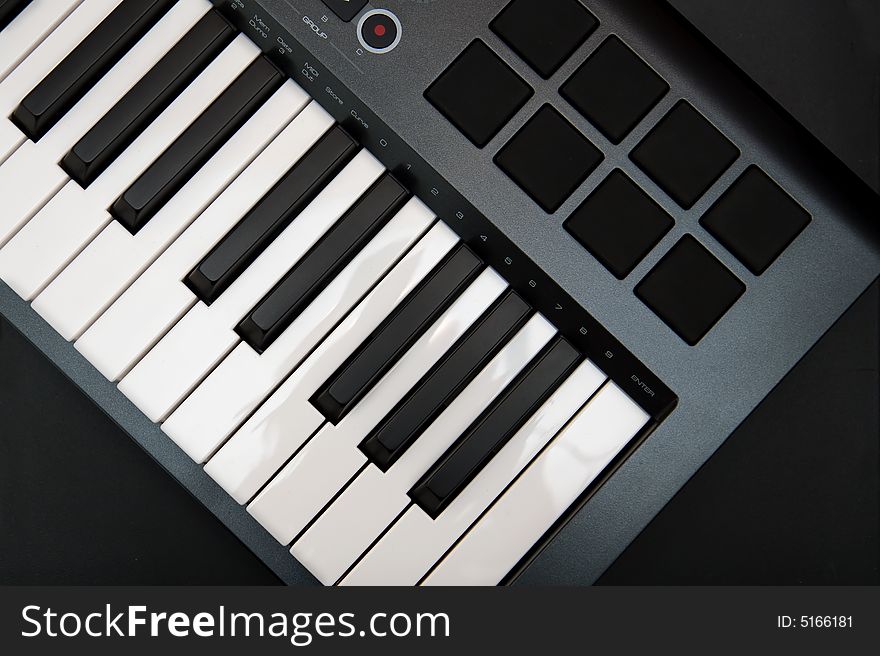The Part of Professional MIDI-keyboard with 8 trigger pads on black background