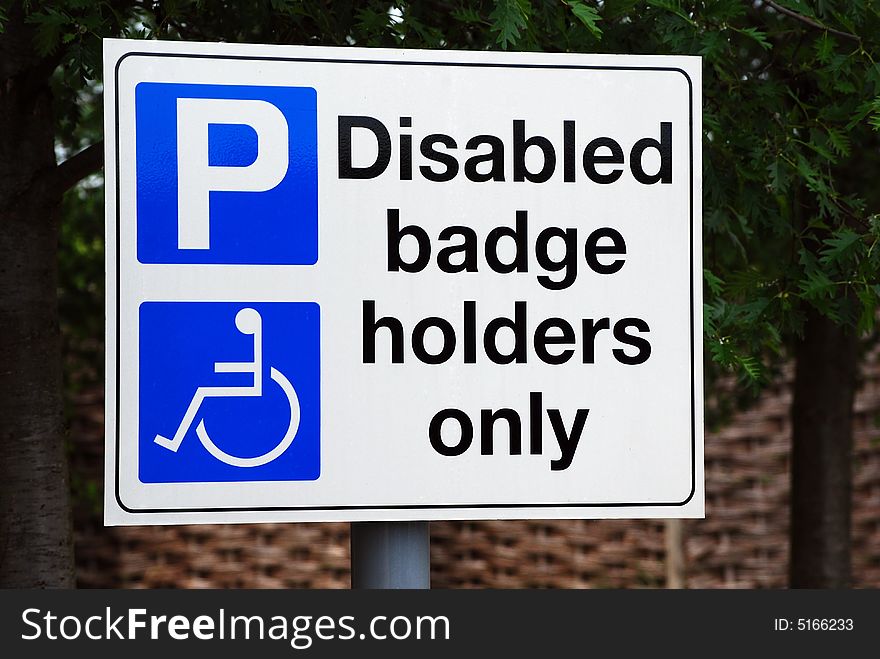 Shot of a disabled parking sign in a car park. Shot of a disabled parking sign in a car park