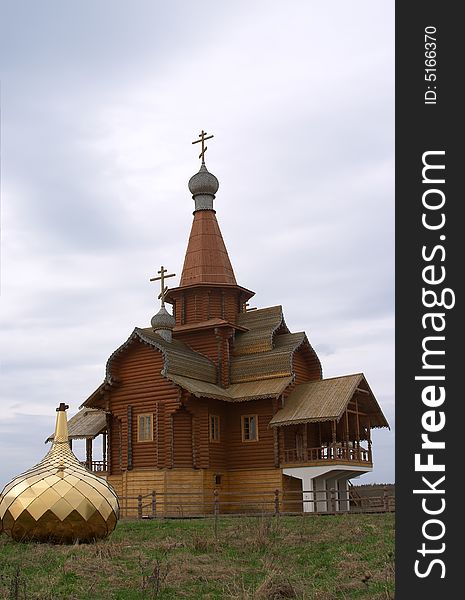 Wooden chapel with golden dome on the ground. Wooden chapel with golden dome on the ground