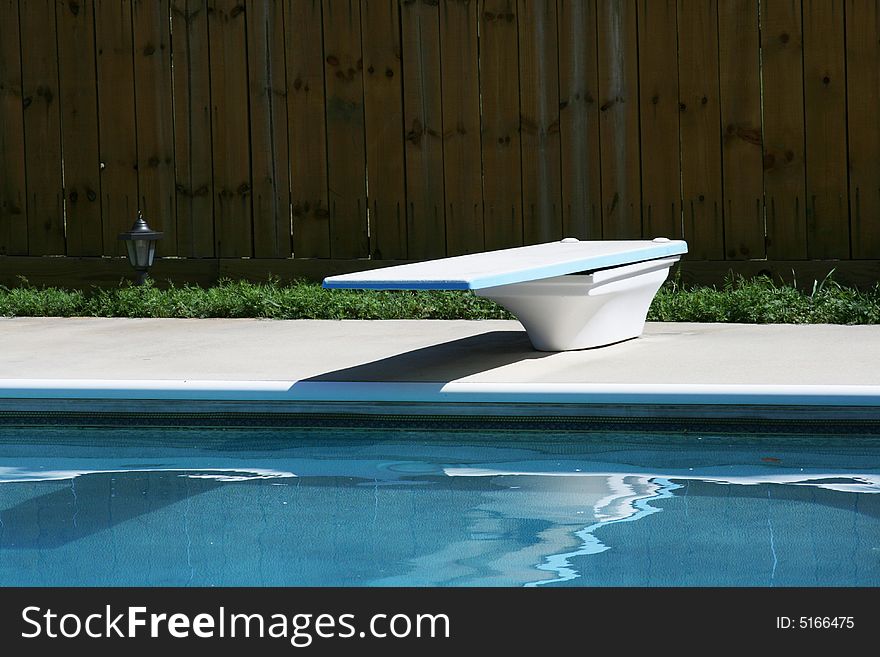 Swimming pool with contrete deck and diving board