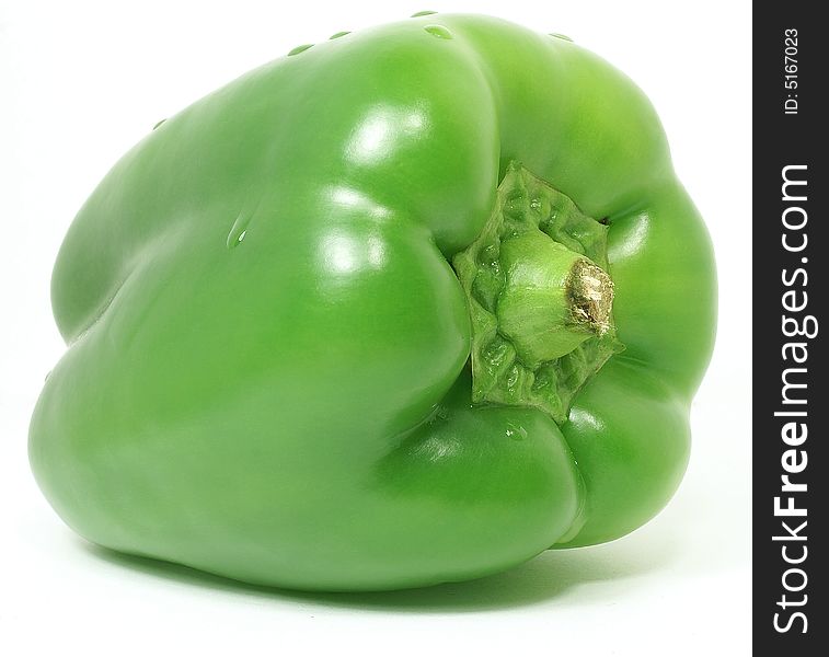 Isolated big nice green paprika with water drops against white. Isolated big nice green paprika with water drops against white