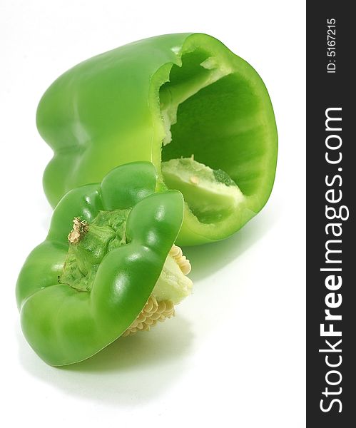 Isolated big сut green paprika with seeds against white. Isolated big сut green paprika with seeds against white
