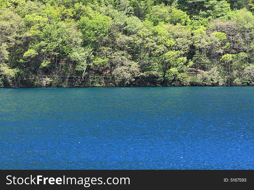 Blue lake in jiuzhaigou valley scene，sichuan province