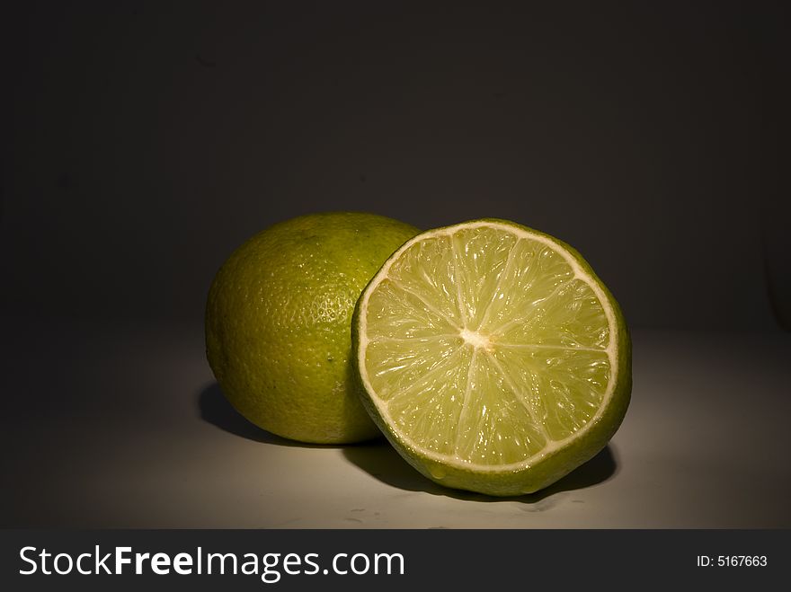 A cut lime over the dark background