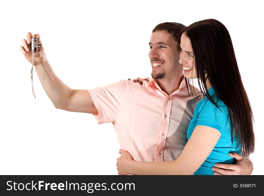 Young couple taking a photo of themselves (isolated on white)