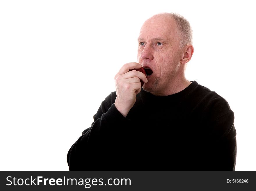 An older guy in a black shirt eating a fresh red apple. An older guy in a black shirt eating a fresh red apple