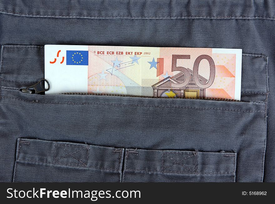 Euro in the pocket of a casual garment.  Photographed in a studio.