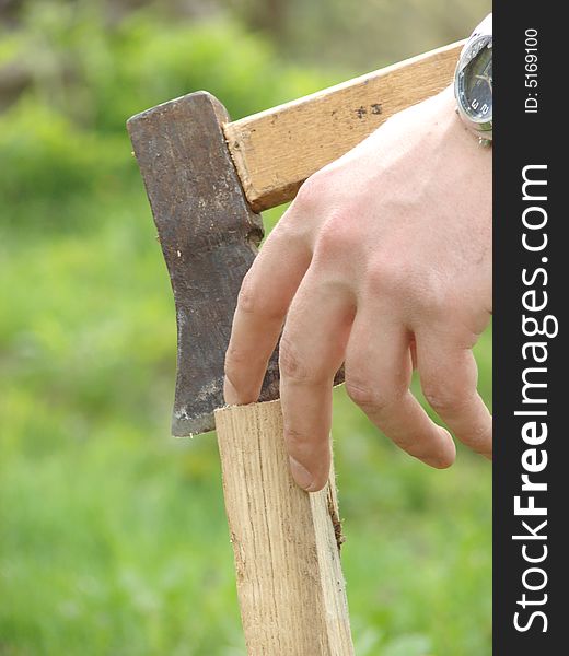 Wooden chuck and metal axe with fingers. Wooden chuck and metal axe with fingers