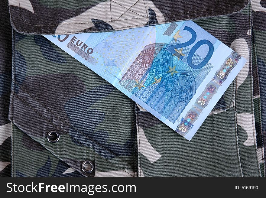 Euro in the pocket of a casual garment. Photographed in a studio.