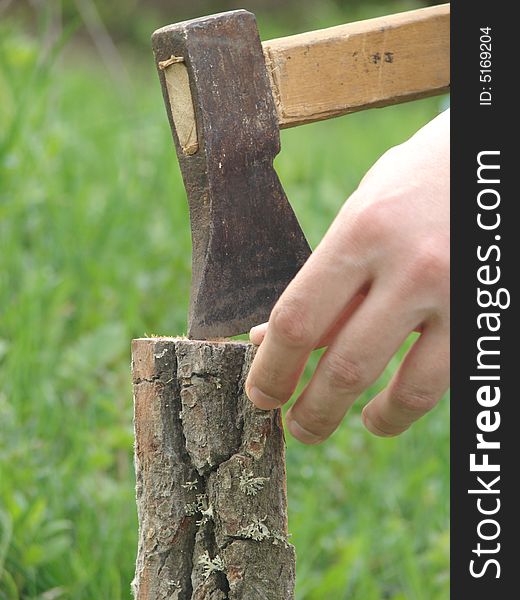 Wooden chuck and metal axe with fingers. Wooden chuck and metal axe with fingers
