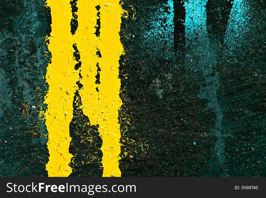 Yellow and blue paints leaking on dark background