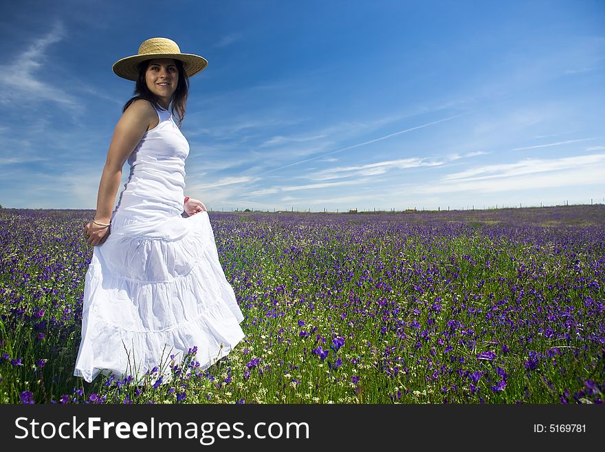 Beautiful young woman with white dress in nature