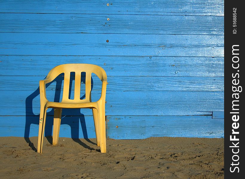 Yellow chair with blue background