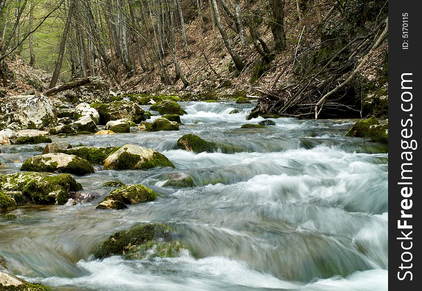 Forest stream running over mossy rocks, long exposure. Forest stream running over mossy rocks, long exposure