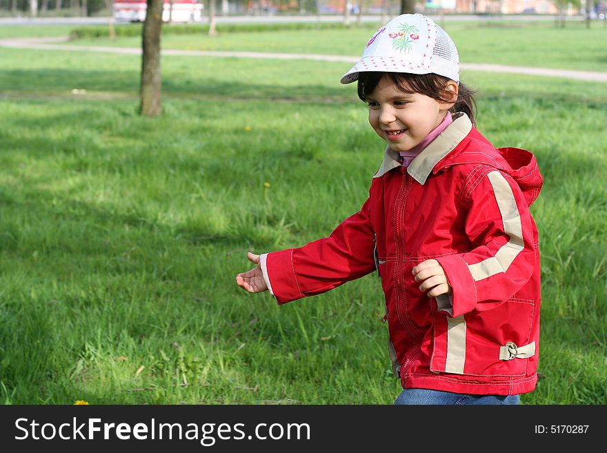 Little girl running in the spring park