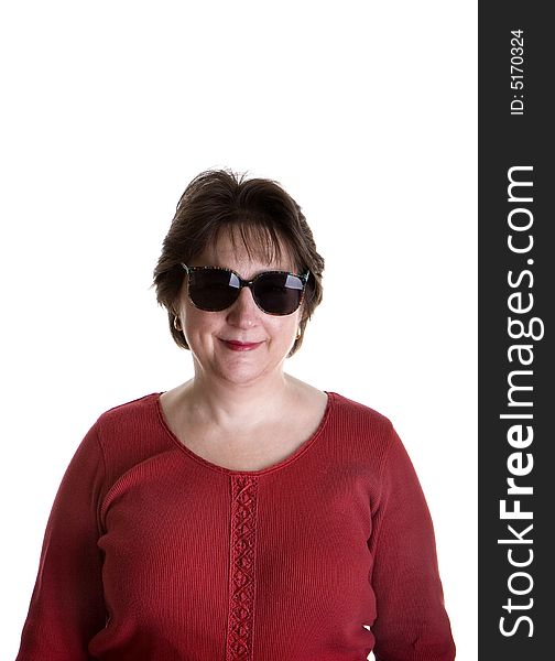 An attractive middle aged woman in red wearing sunglasses and smiling. An attractive middle aged woman in red wearing sunglasses and smiling