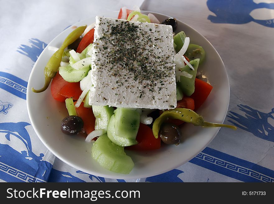 Greek salad in bowl on desk