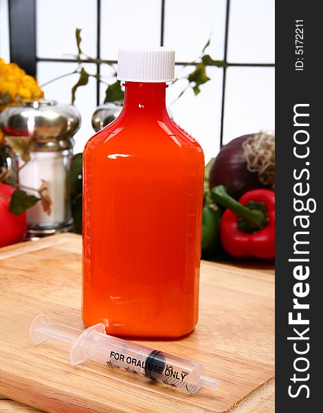 Bottle of liquid oral antibiotic and dispenser in kitchen. Bottle of liquid oral antibiotic and dispenser in kitchen.