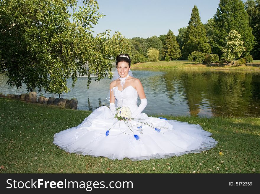 Beautiful bride with her bouquet at the park. Beautiful bride with her bouquet at the park.