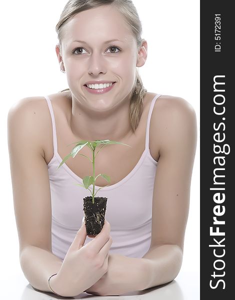 Young woman holding young sprout in the hands.