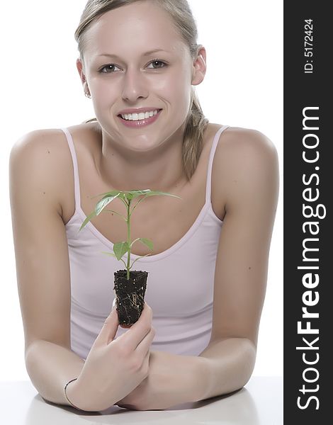 Young Woman Holding Young Sprout In The Hands.