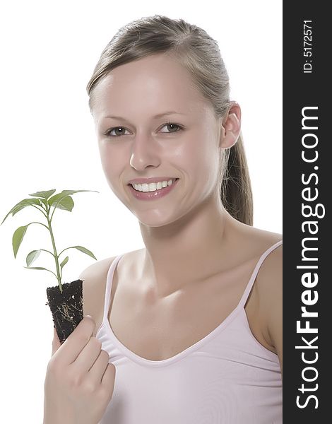 Young woman holding young sprout in the hands.