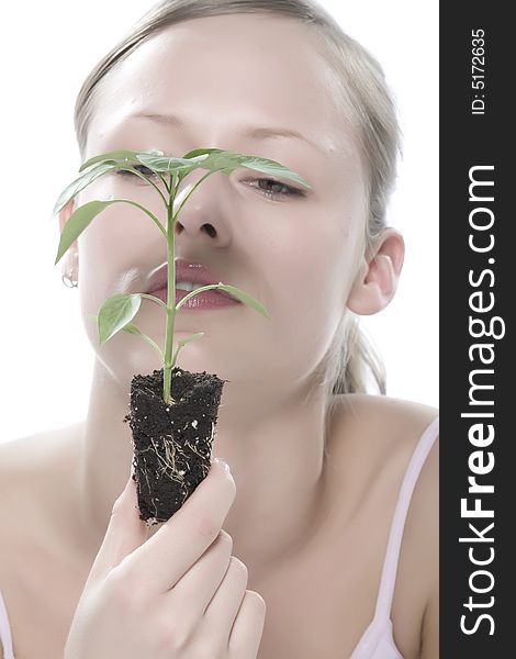 Young Woman Holding Young Sprout In The Hands.