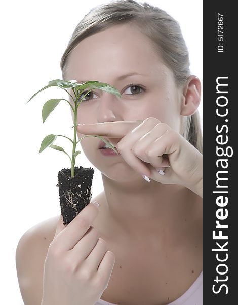 Young woman holding young sprout in the hands.