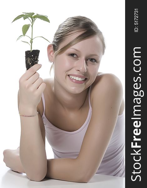 Young woman holding young sprout in the hands.