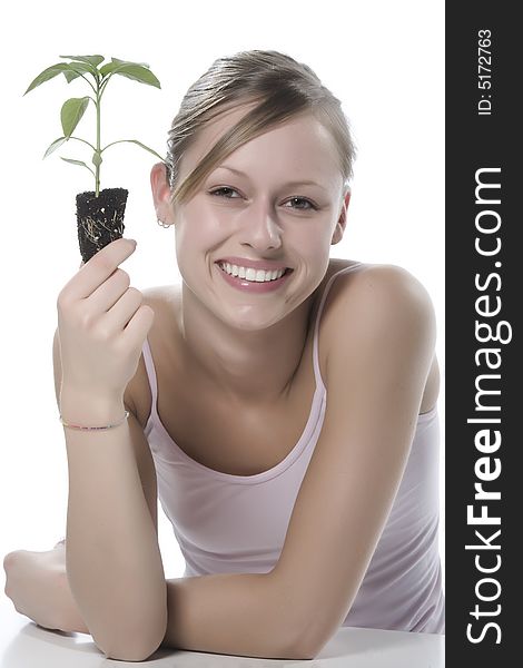 Young woman holding young sprout in the hands.