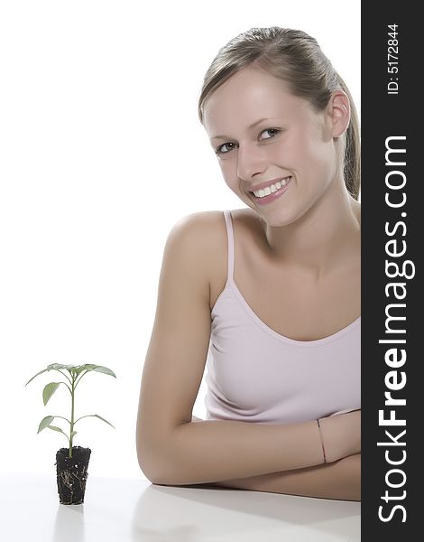 Young Woman Holding Young Sprout In The Hands.