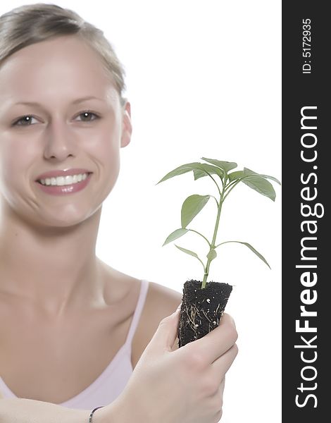 Young woman holding young sprout in the hands.