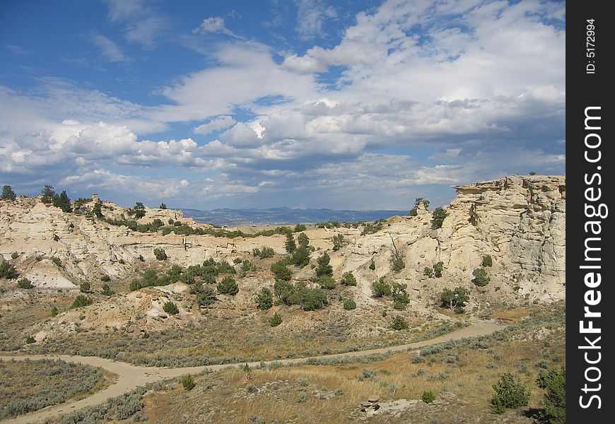 A landscape of Castle Rock in Wyoming on a partly cloudy day.