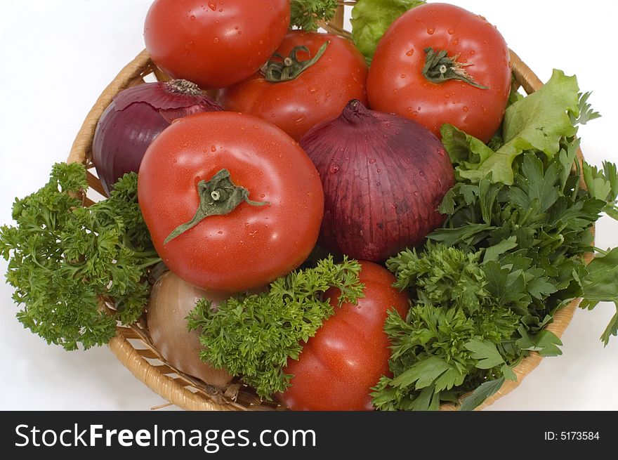 Fresh vegetables in a basket on a white background. Fresh vegetables in a basket on a white background.