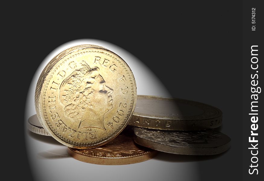 UK coins on white with spotlight effect