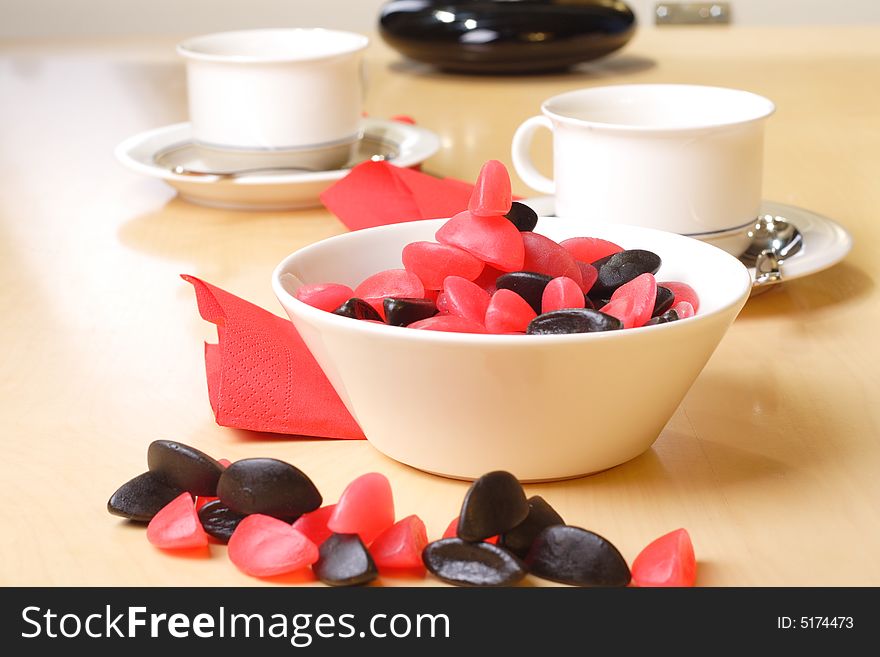 Candy with coffee cups in the background. Candy with coffee cups in the background