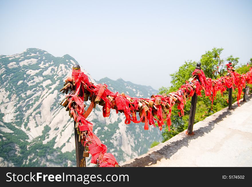 Pilgrims tie red ribbons to the trees outside of the taoist temple. Recently-married locals will climb to the summits to add a lock the chains to symbolize their everlasting love. A similar practice is done on the Great Wall. Pilgrims tie red ribbons to the trees outside of the taoist temple. Recently-married locals will climb to the summits to add a lock the chains to symbolize their everlasting love. A similar practice is done on the Great Wall.