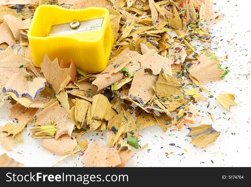 Close-up of wood waste heap and sharpener, white background. Close-up of wood waste heap and sharpener, white background