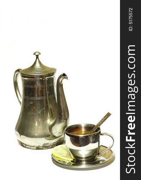 Teapot with cup of tea on white background isolated