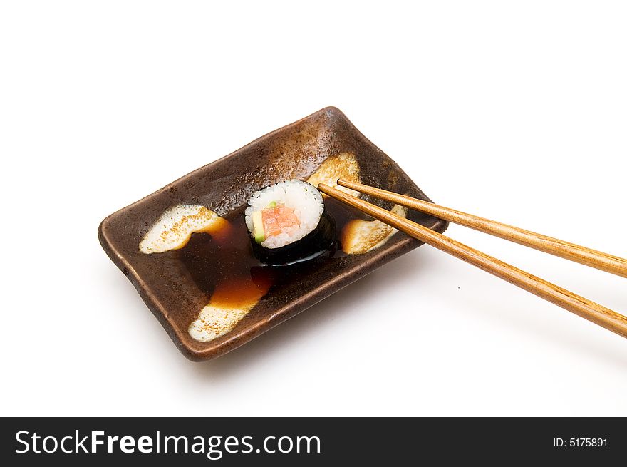 Salmon roll with avocado in soy isolated om white. Salmon roll with avocado in soy isolated om white