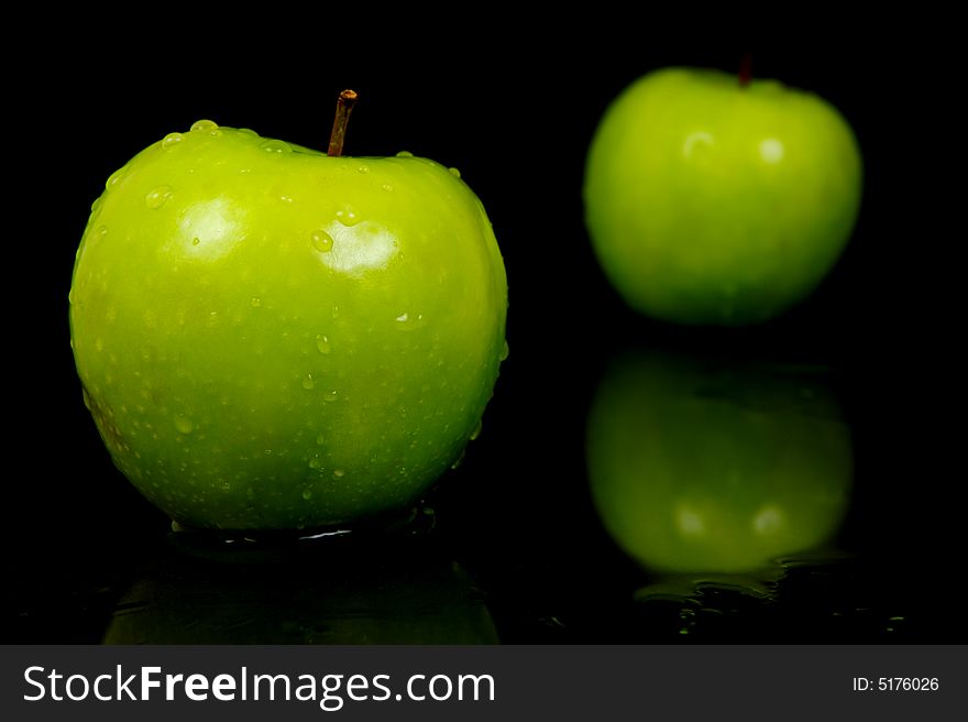 Green apples isolated against a black background