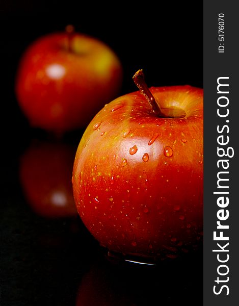 Red apples isolated against a black background