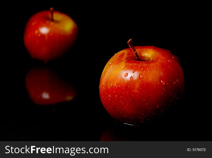 Red apples isolated against a black background