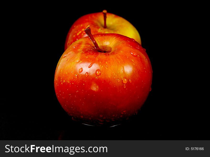Red apples isolated against a black background