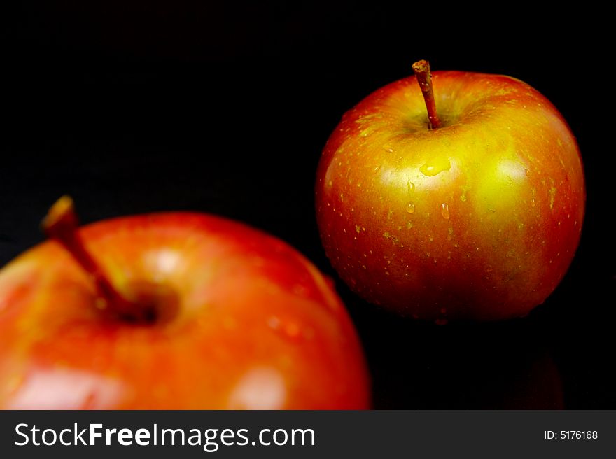 Red apples isolated against a black background