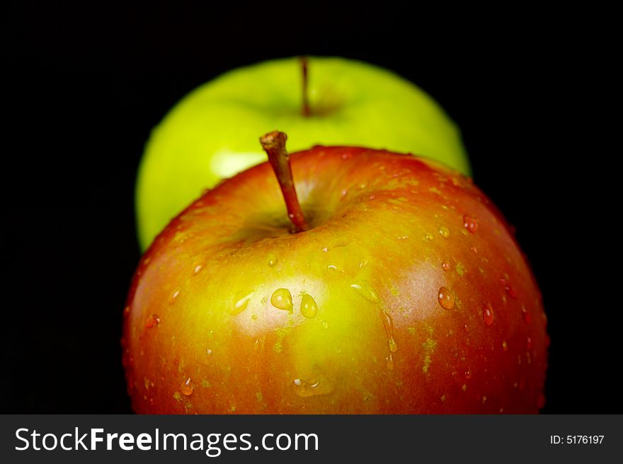 Red & green apples isolated against a black background