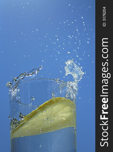 Lemon in a glass of water on sky. Lemon in a glass of water on sky