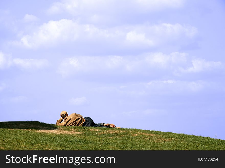 The man having a rest on a lawn in park