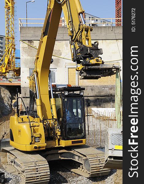 Large bulldozer, digger, excavating inside construction-site. Large bulldozer, digger, excavating inside construction-site