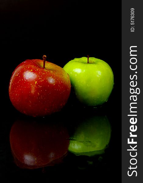 Red & green apples isolated against a black background